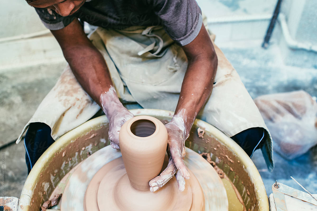 Male Artisan Potter Making Vase on Flywheel