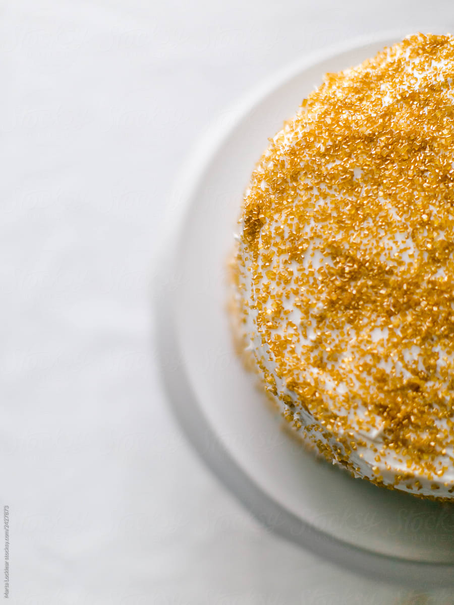 Gold Sprinkle Cake On A White Cake Stand by Stocksy Contributor Marta  Locklear - Stocksy