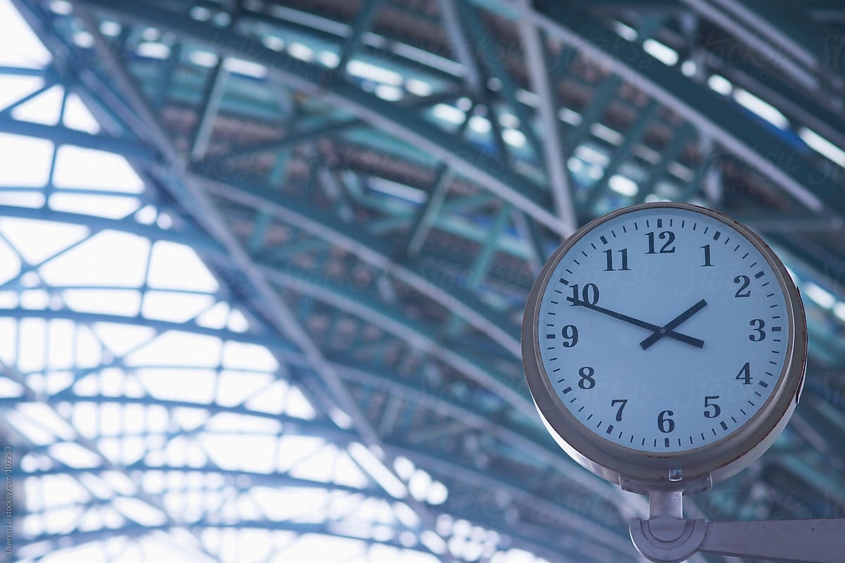 Clock hanging in modern railway station