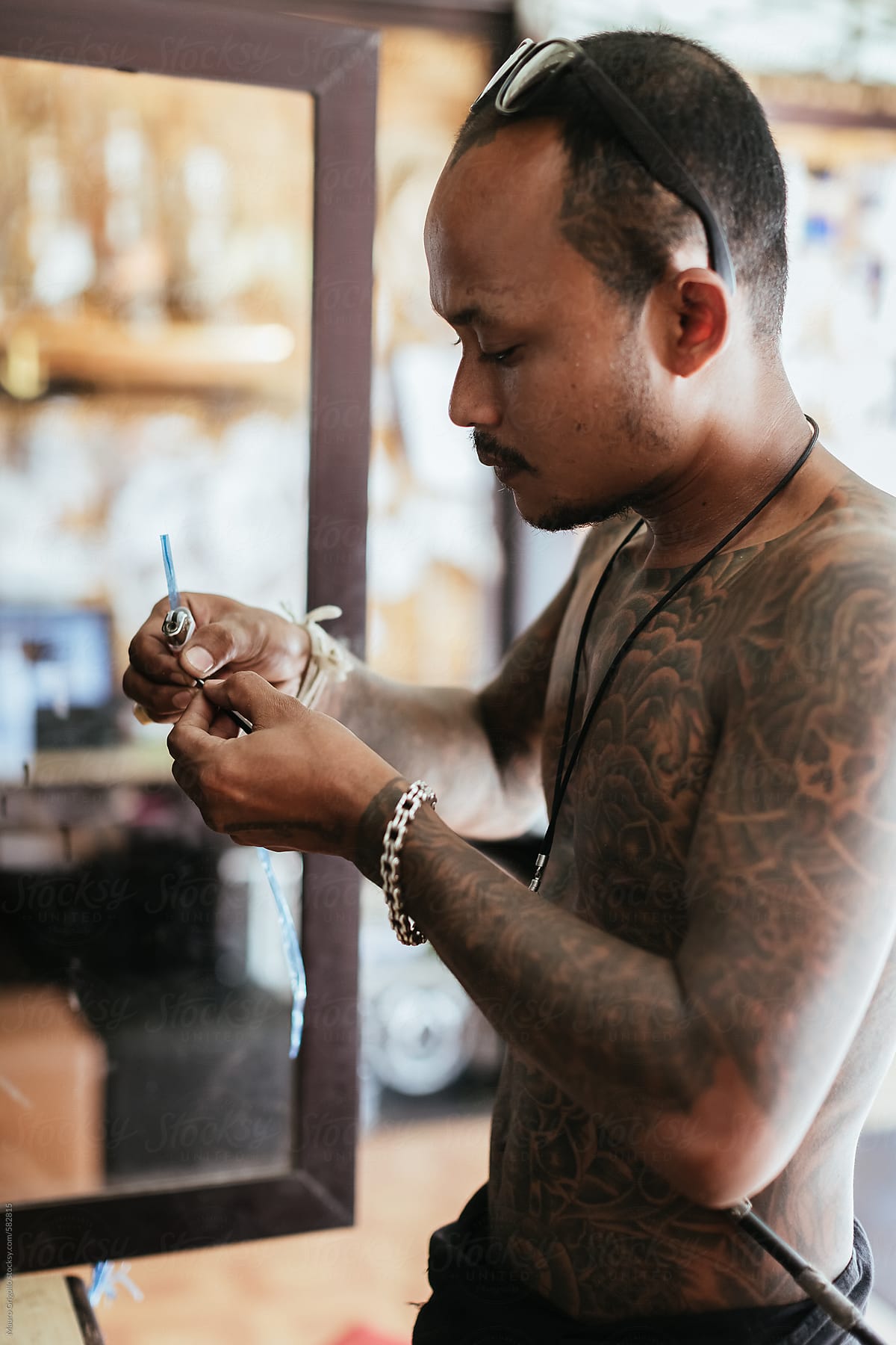 Thai tattoo artist get ready for a new tattoo inside his studio