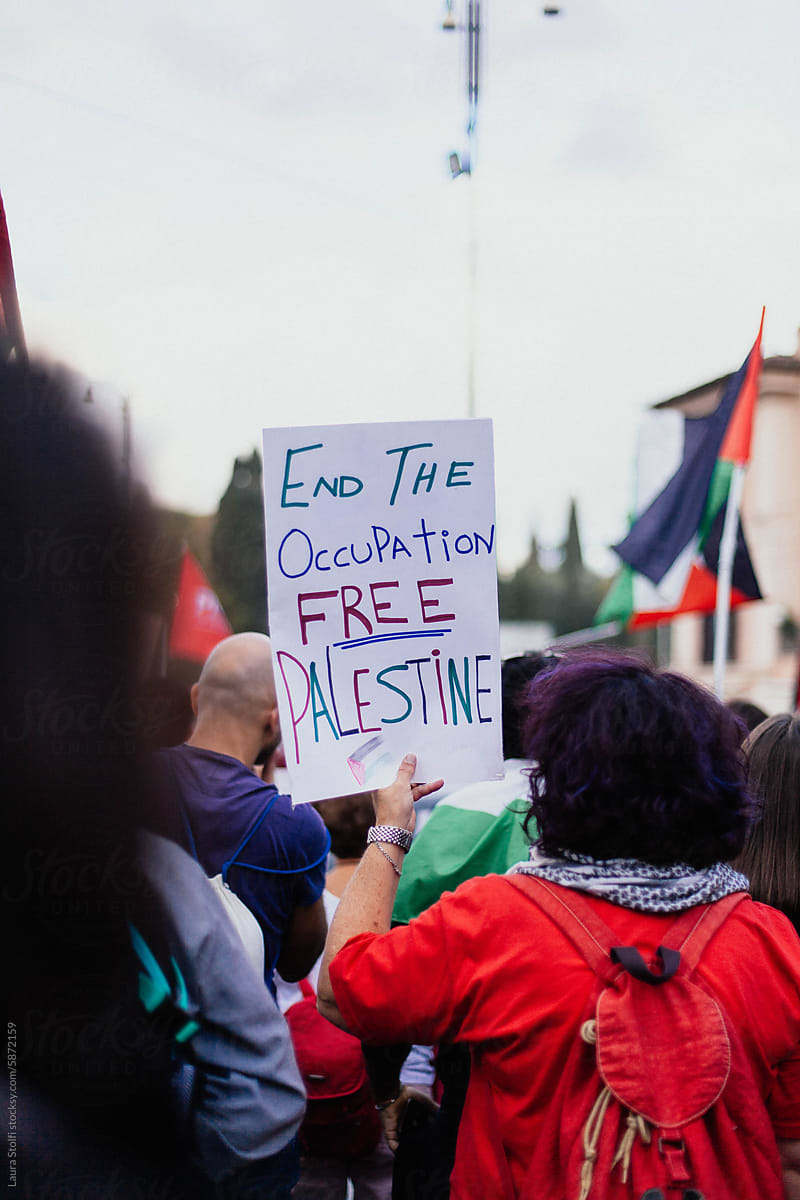 Protest sign amongst the crowd during a pro Palestine rally