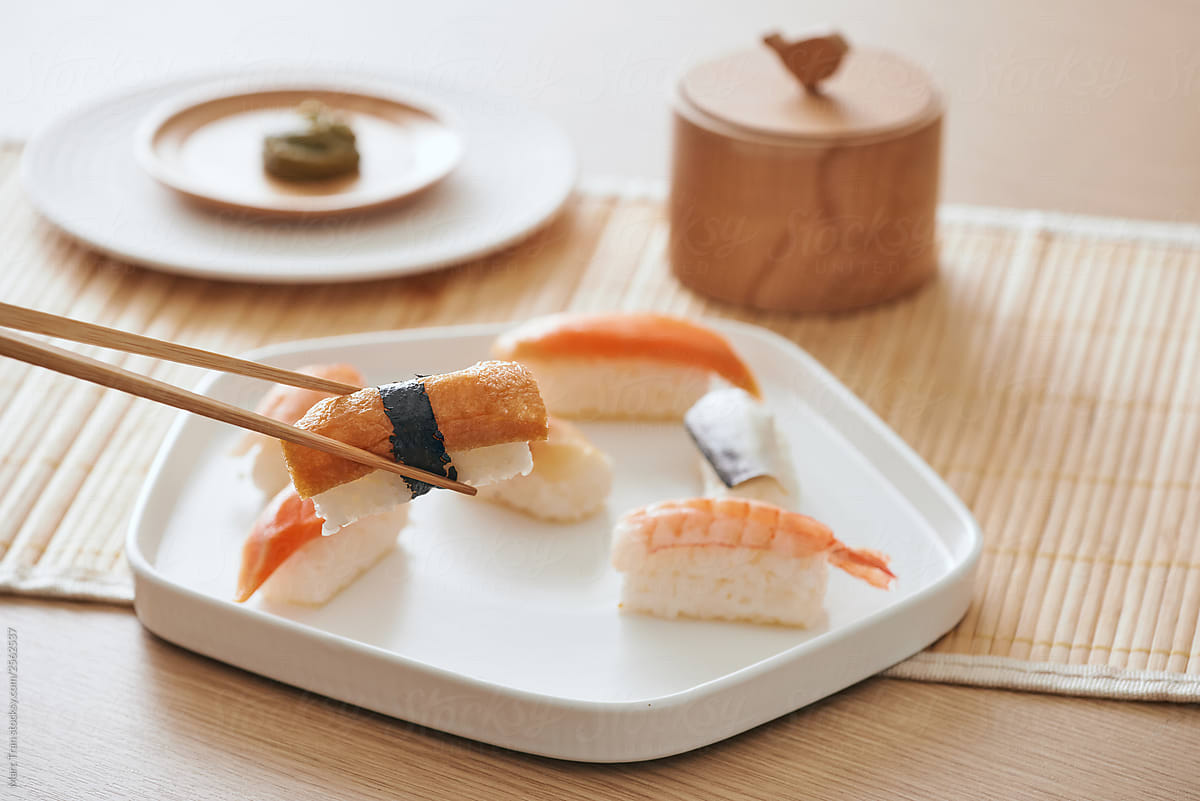 Homemade sushi with chopstick on table.