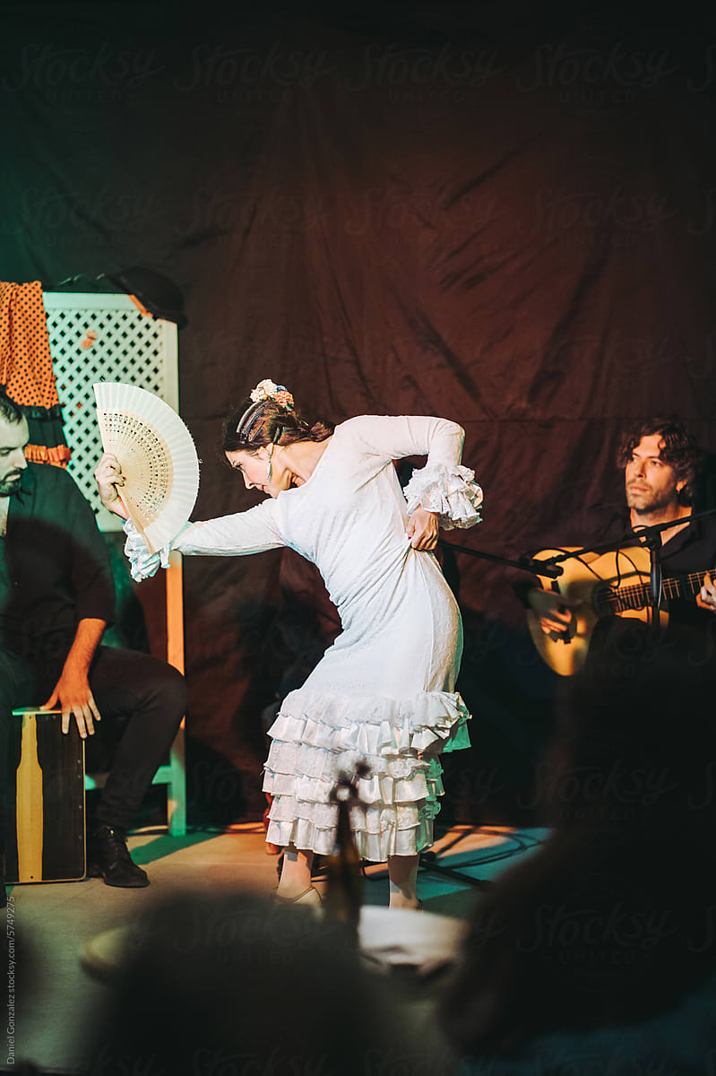 Graceful woman dancing flamenco during show