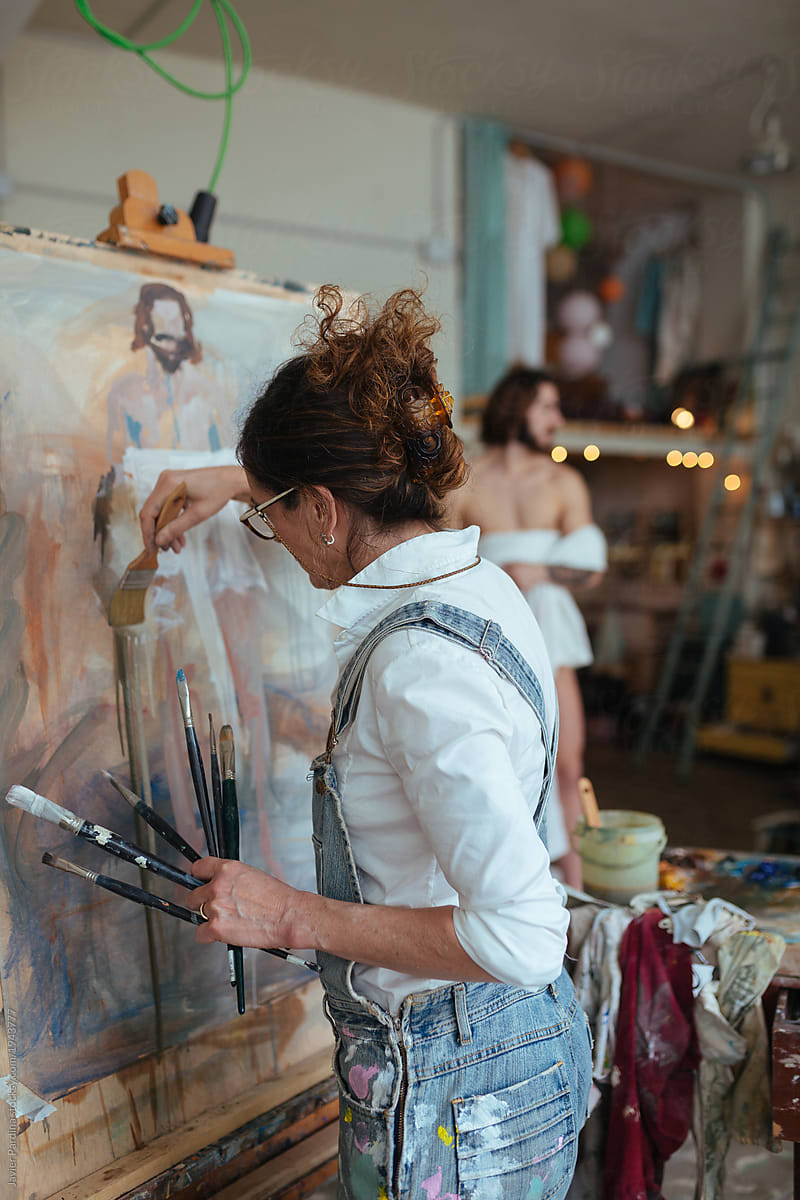 Woman drawing model with artistic technique on canvas