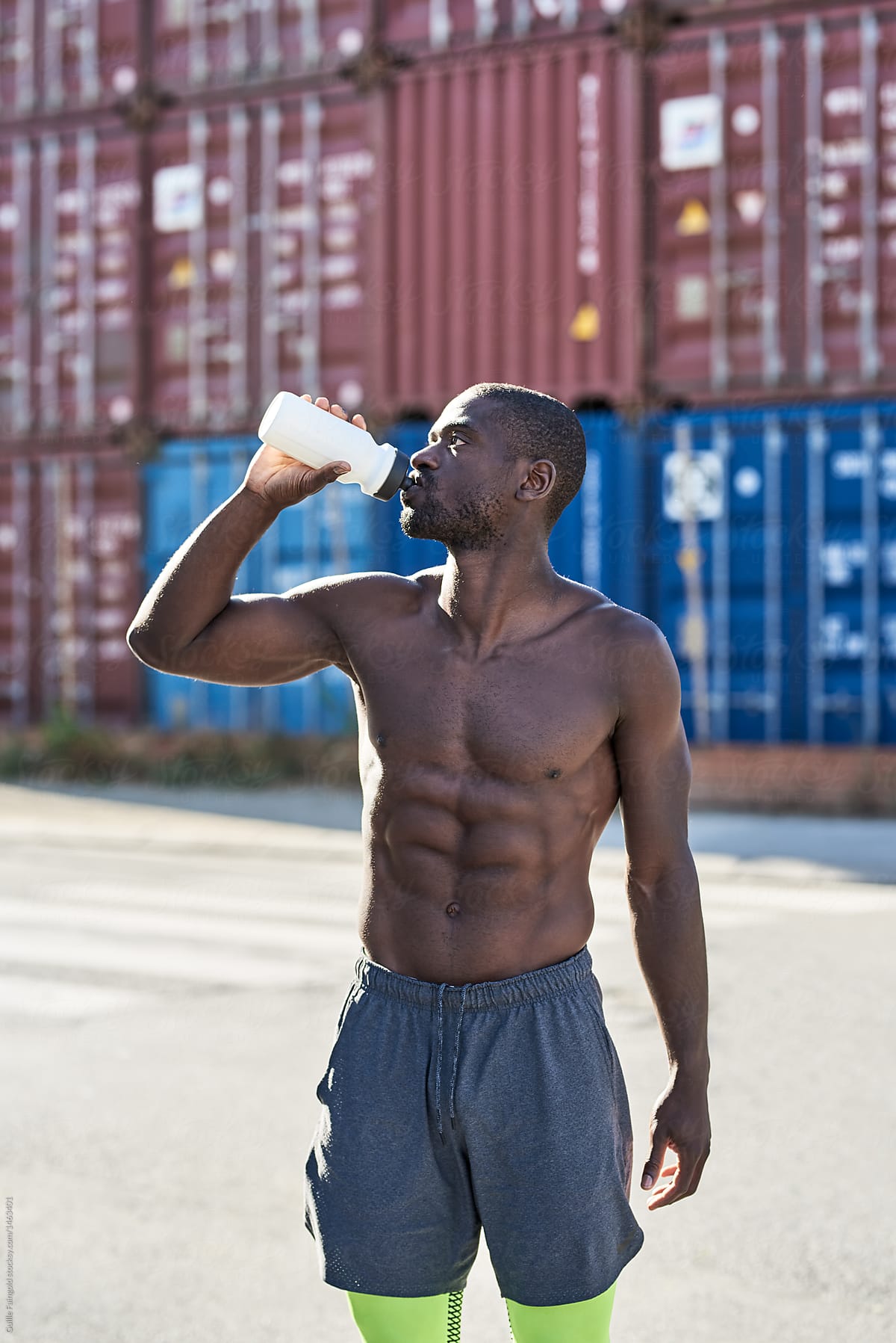 Shirtless Athlete Drinking Water After Training by Guille Faingold
