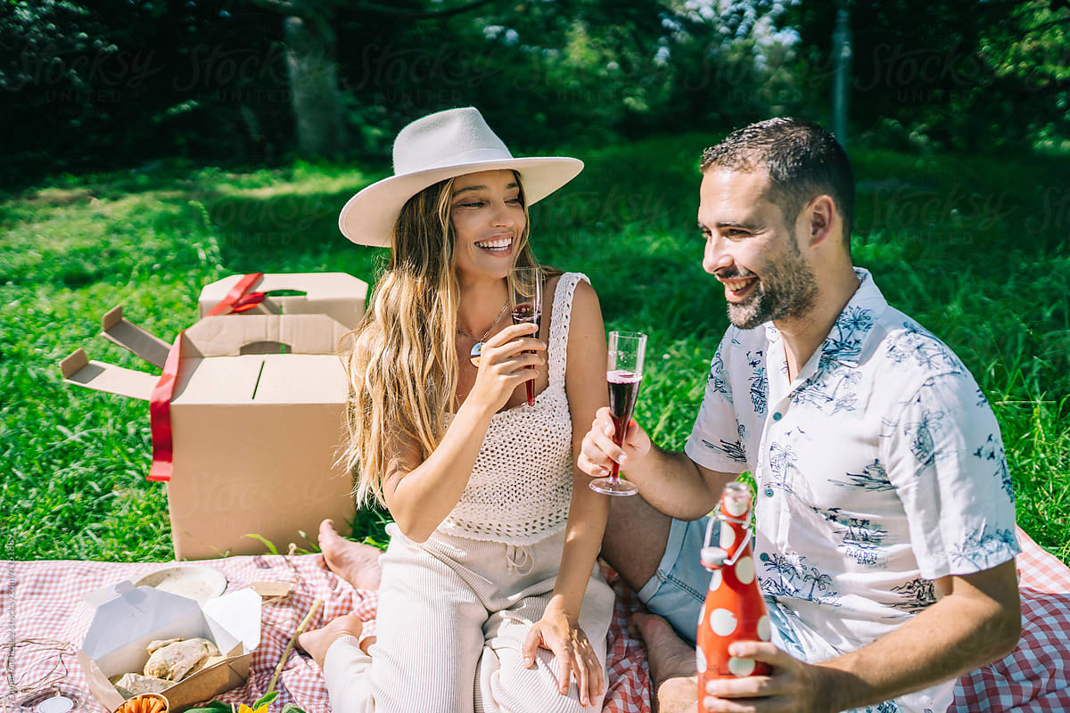 Happy couple with wine during picnic