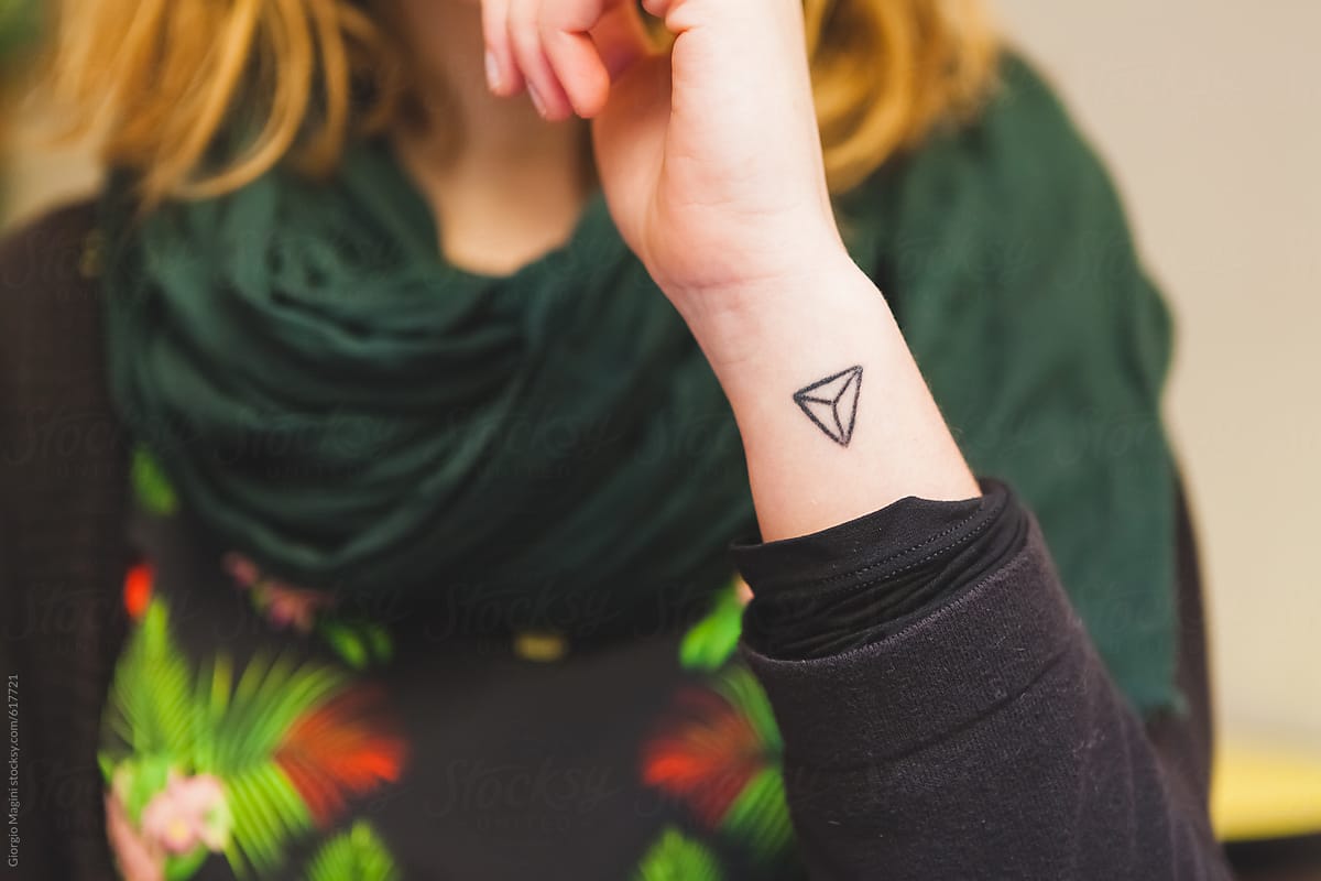 Triangle Tattoo On The Wrist Of A Teenage Girl