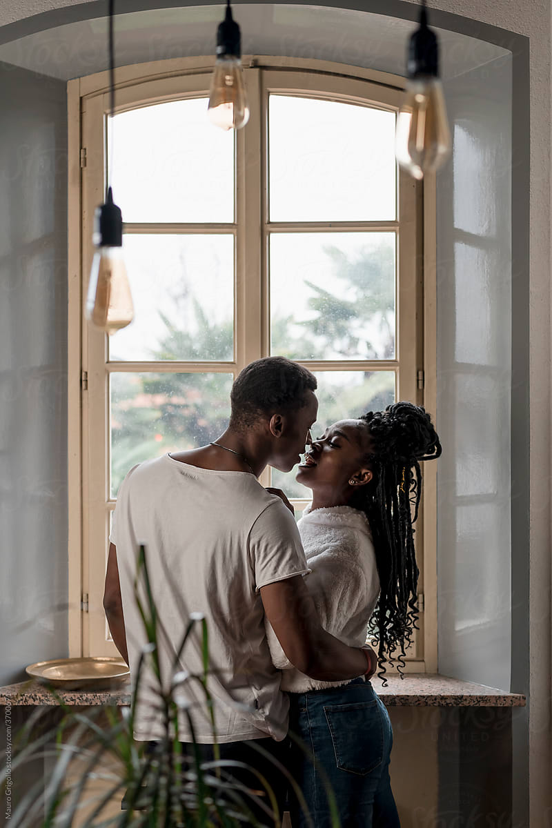 Couple Kissing At Home By Stocksy Contributor Mauro Grigollo Stocksy