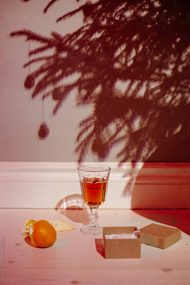 Orange and champagne near shadow of Christmas tree
