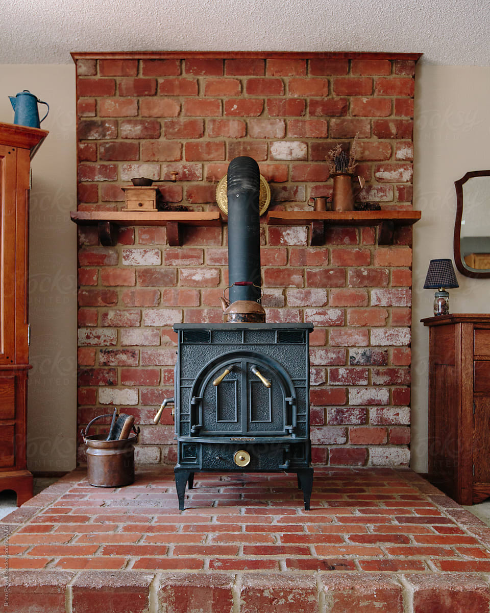 Old Wood Stove On Brick Hearth by Stocksy Contributor Brian Powell -  Stocksy