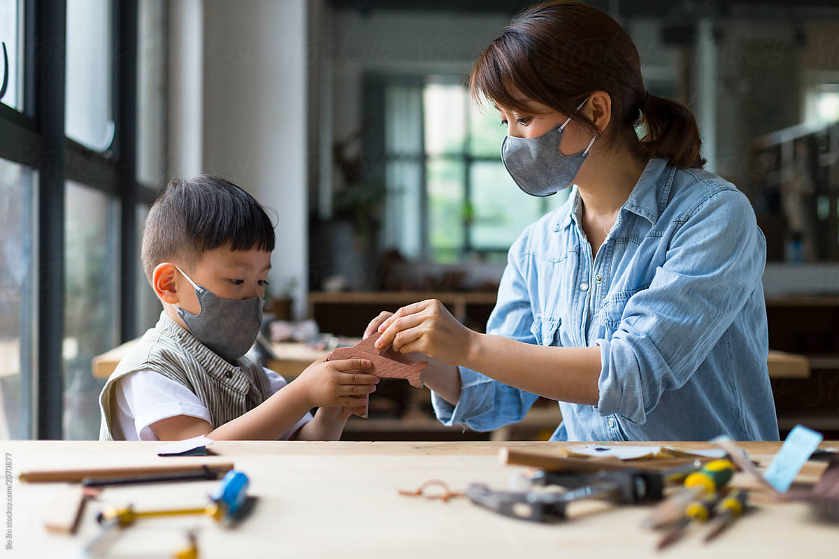 Female carpenter working together with her son