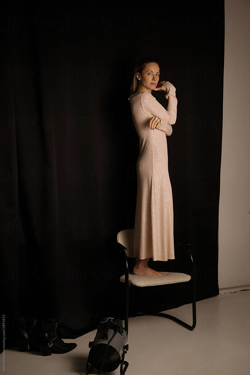 Elegant Woman Posing in a Long Dress During a Studio Photo Shoot
