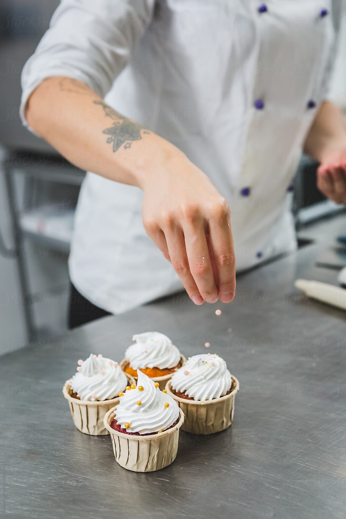 Pastry Chef Preparing Cupcakes in a Professional Kitchen