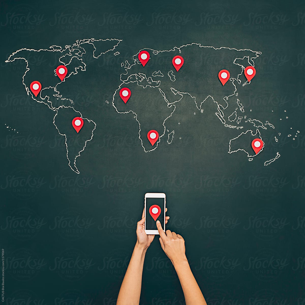 Internet search with mobile phone. World map on chalkboard with pins.