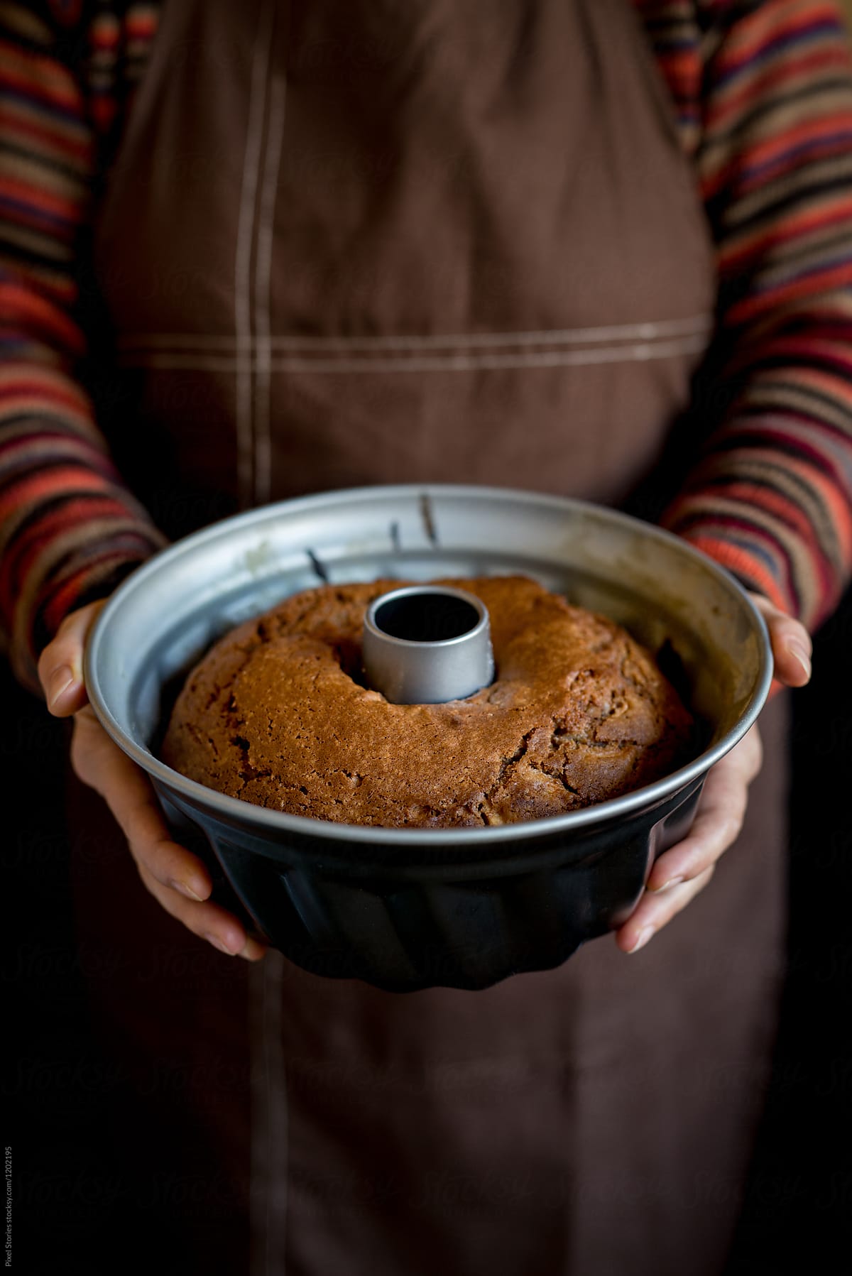 Woman holding just baked cake