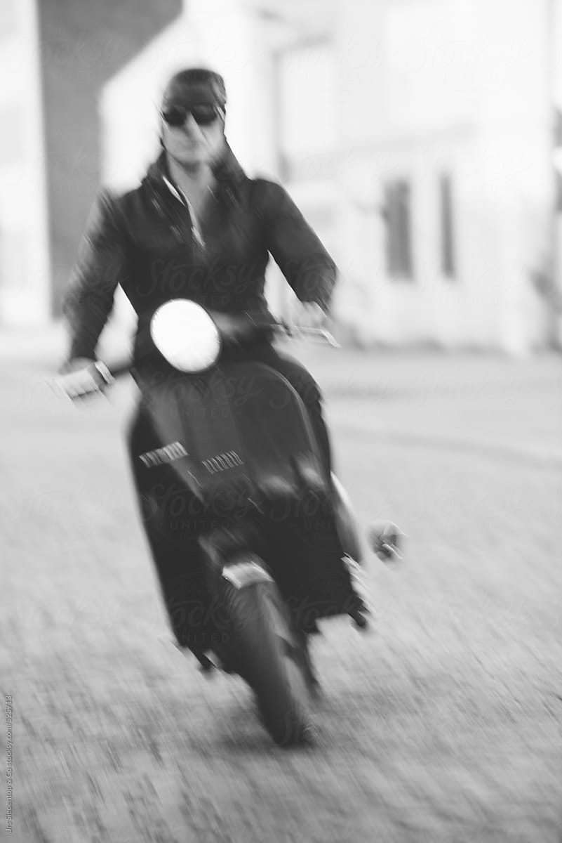 Motion blurred man on scooter