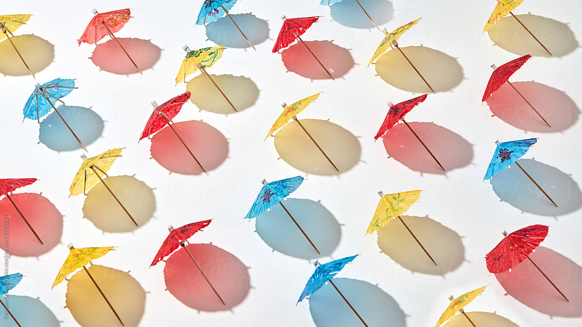 Creative pattern from multicolor cocktail umbrellas.