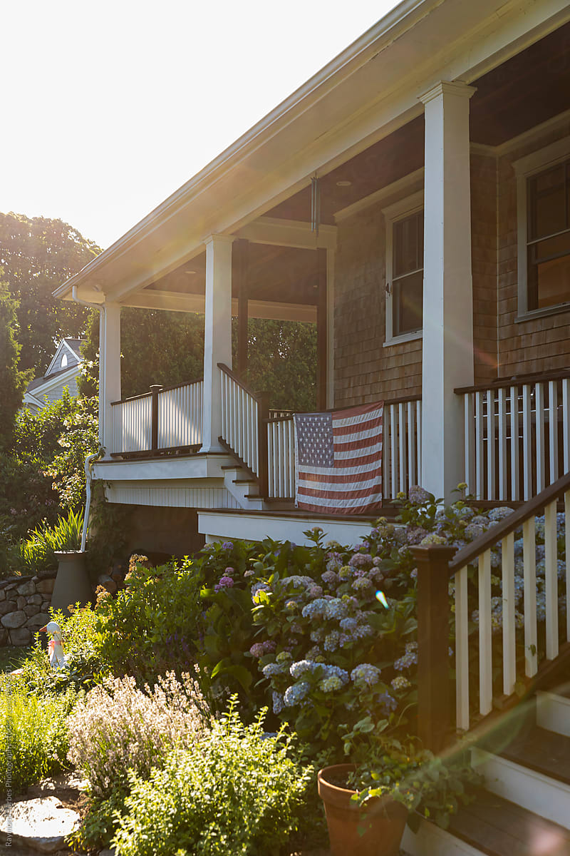 American Flag hanging on Porch with Hydrangea Flowers