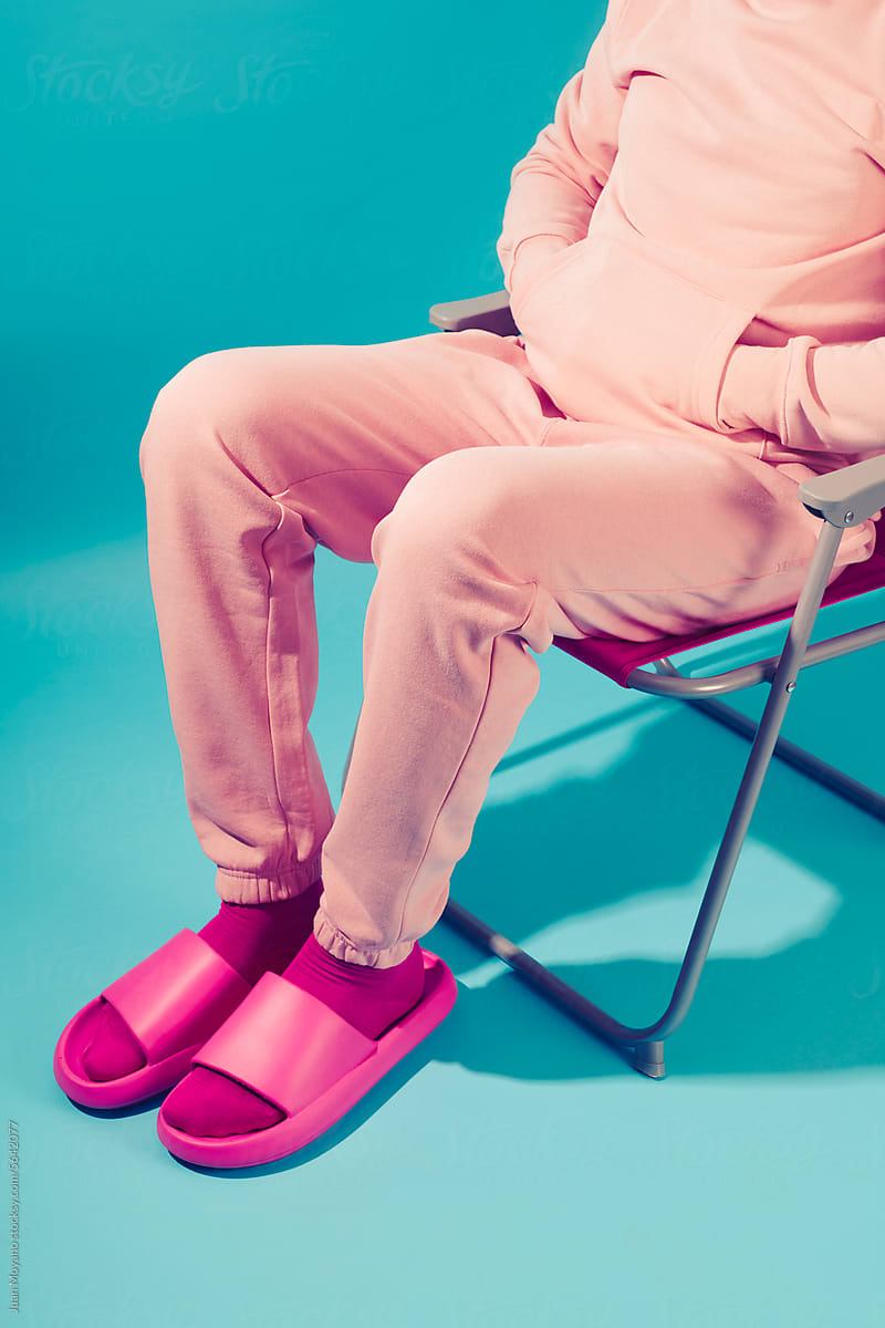 man in pink sitting in a folding chair