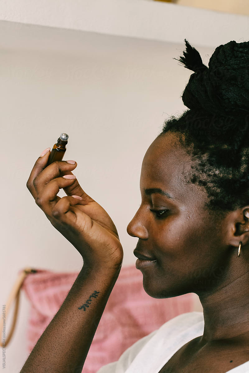Self-Care - Black Woman Smelling Essential Oil on Wrist