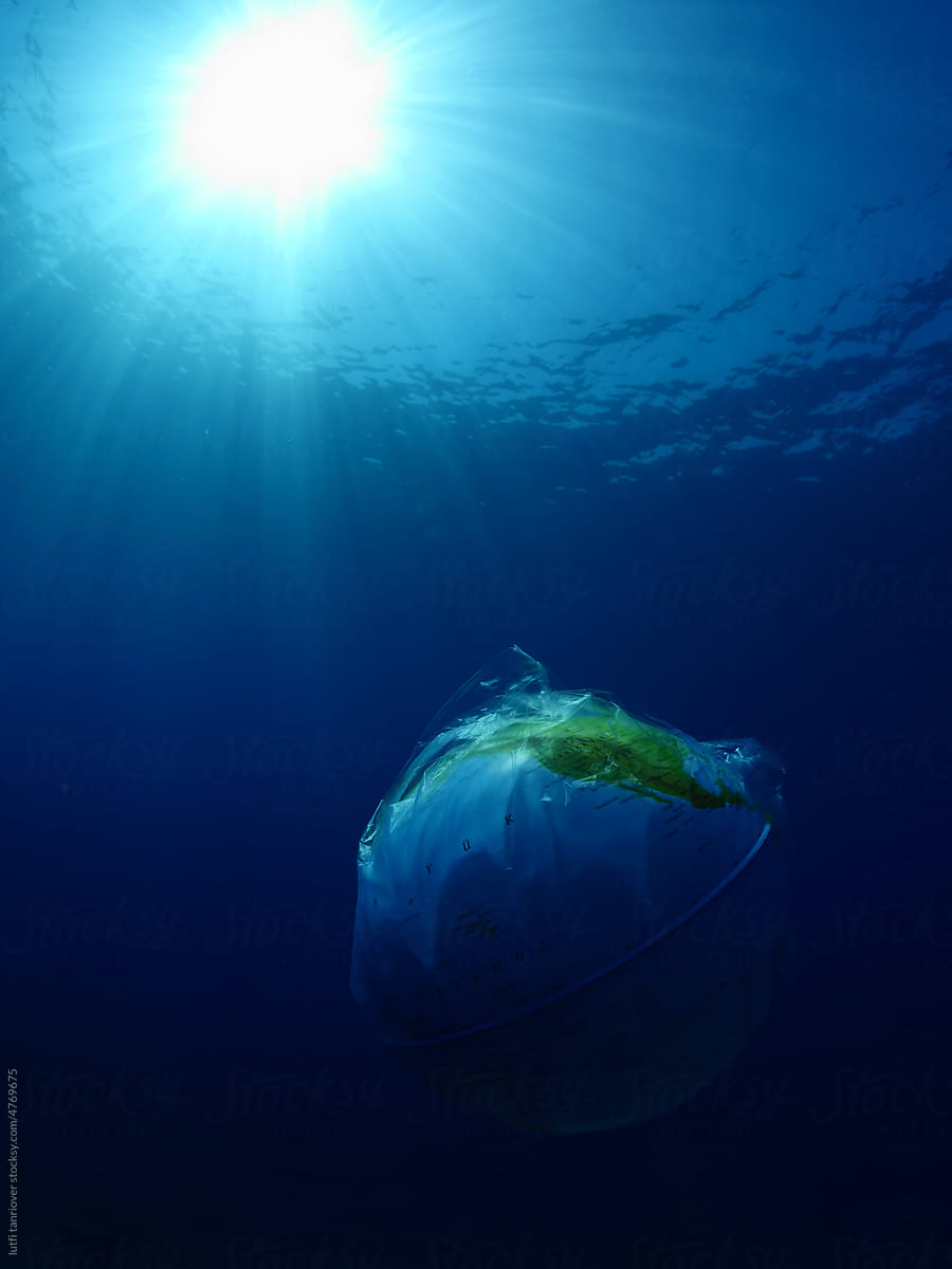 world in plastic bag drifting underwater  ocean pollution scenery