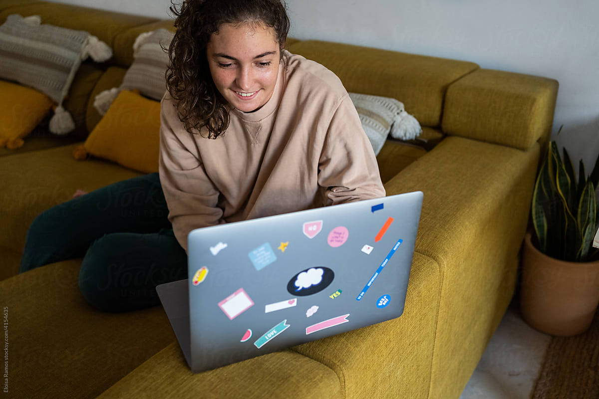 Teenager using laptop in living room