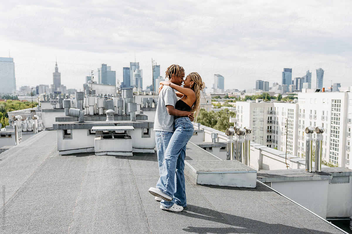 Man and woman kissing on the roof