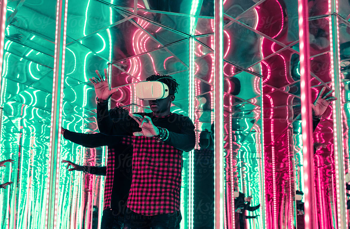  Black Man In VR Goggles In Mirror Maze By Stocksy Contributor Milles 