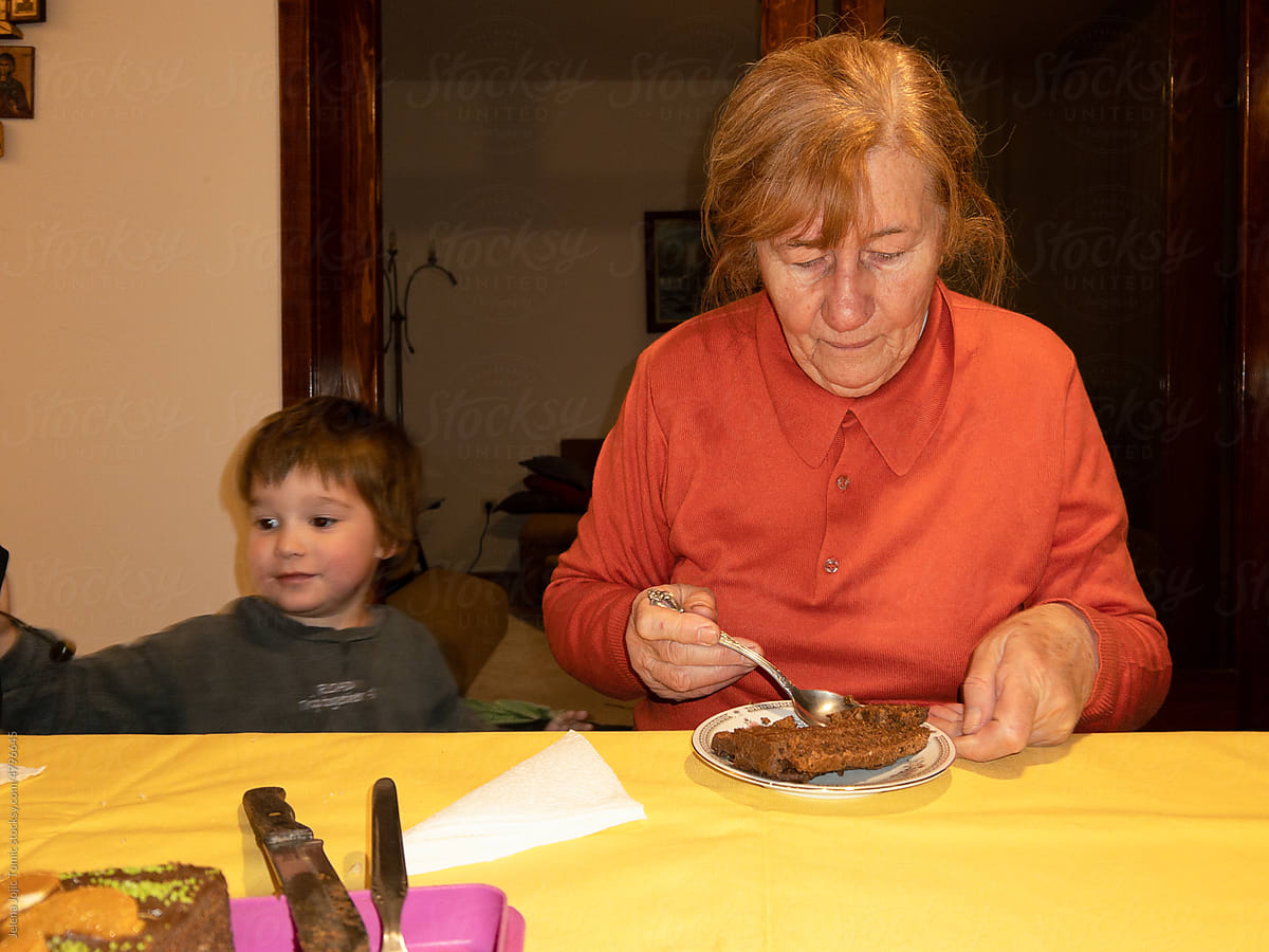User-generated content, an elderly woman eating her birthday cake