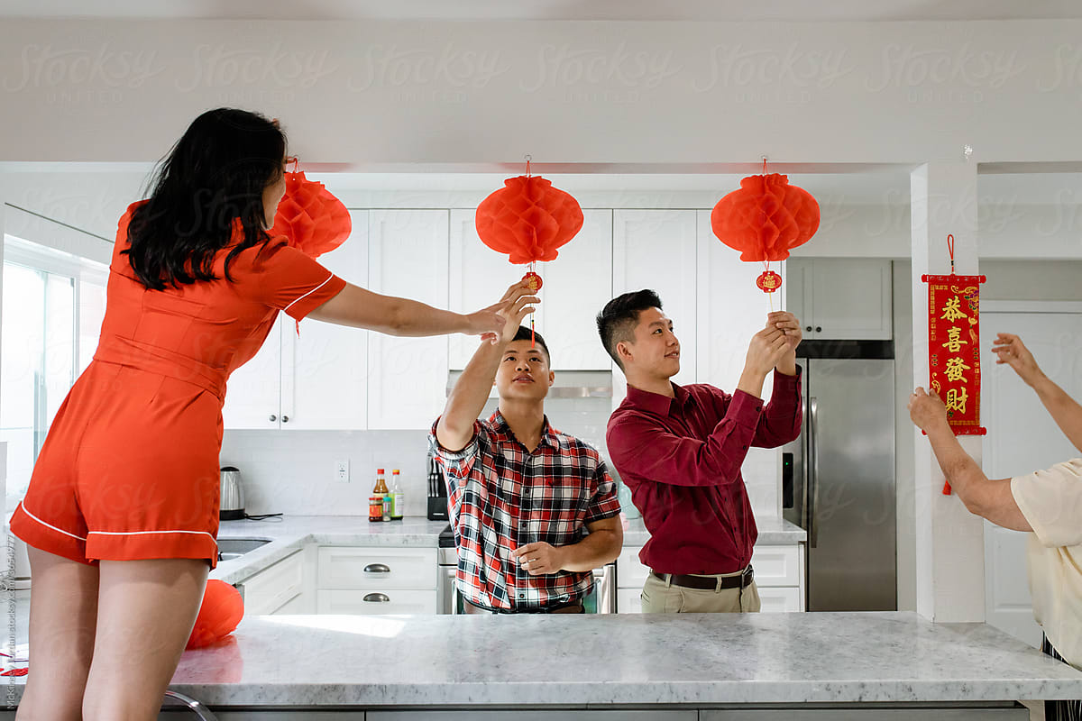 Young Adults Hang Decor for Chinese New Year