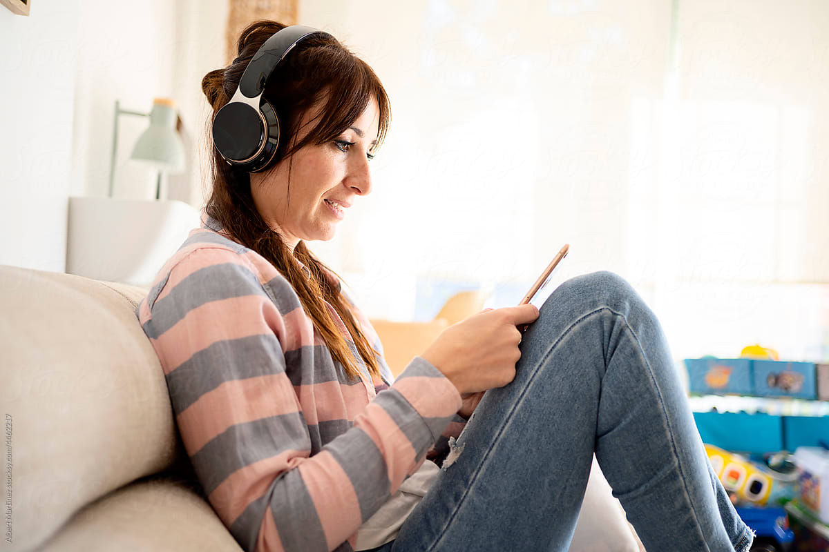 Woman listening to music and browsing smartphone