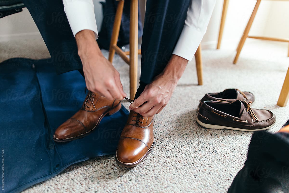 Business man fixing his dress shoes