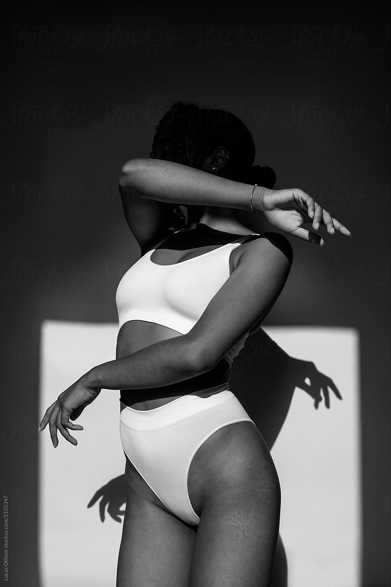 Black Woman In White Underwear by Stocksy Contributor Lucas