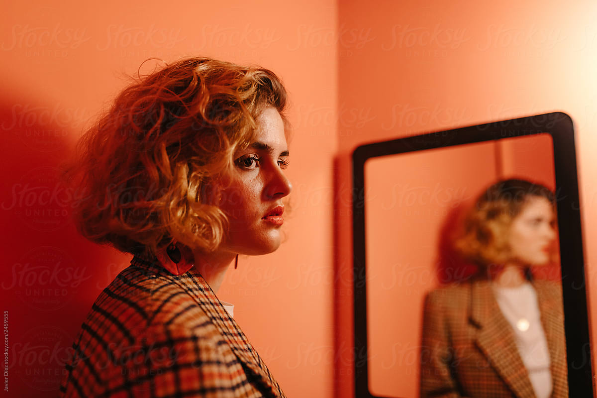 Woman standing in front of mirror