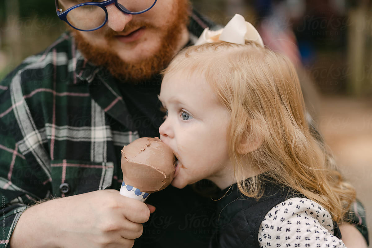 father and daughter eating ice cream