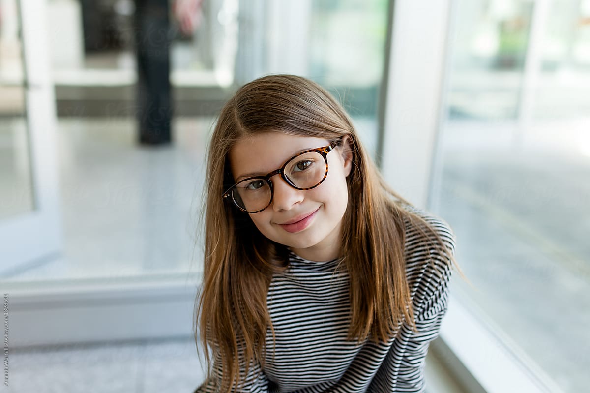 Quietly Confident Preteen Girl Wearing Glasses by Stocksy