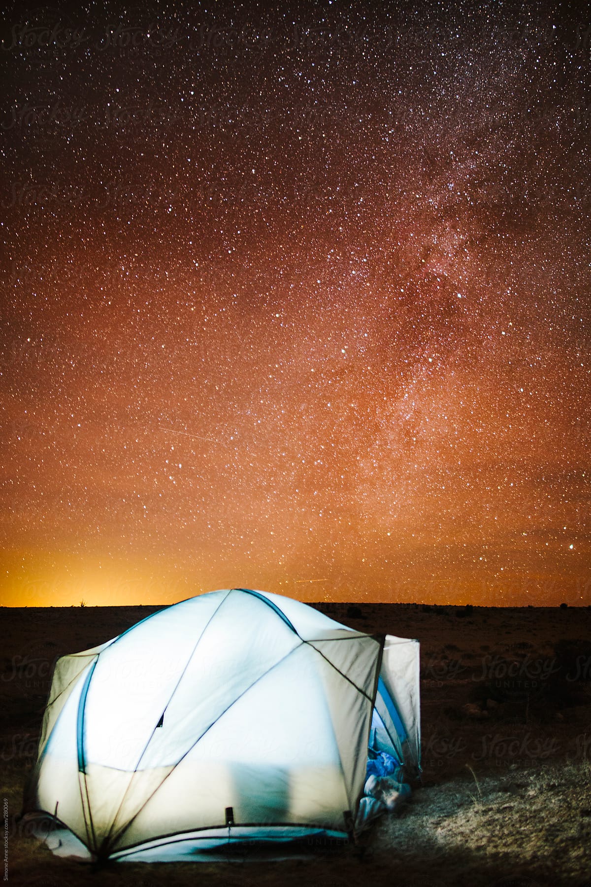 Illuminated tent with starry sky backdrop