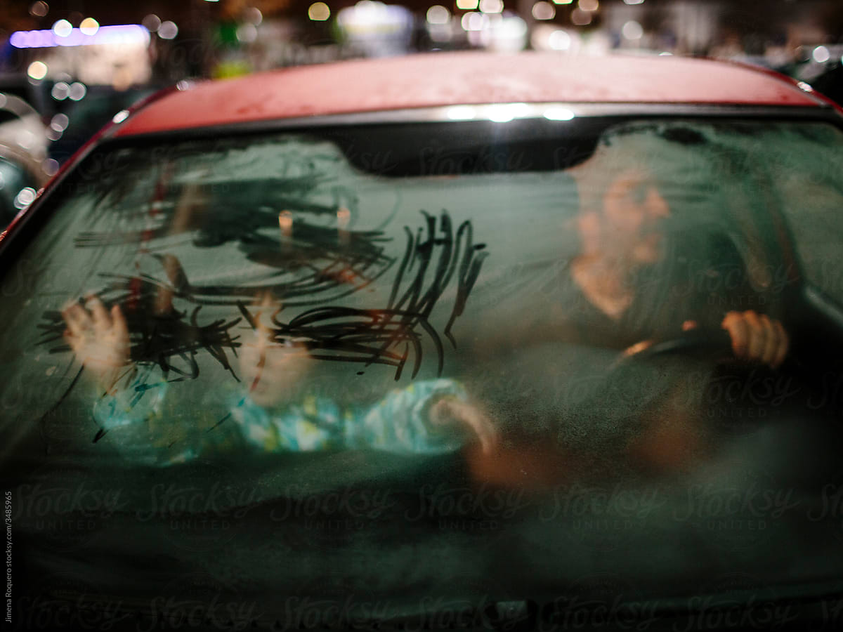 Kid and father inside a car with steamy windows