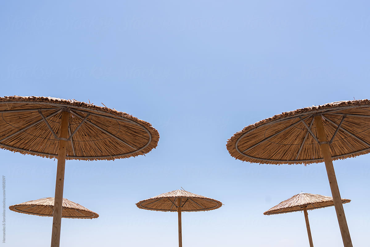 Minimalistic View Of Umbrellas And Blue Sky