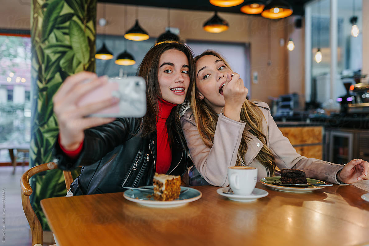 Young friends taking a selfie at a coffee shop
