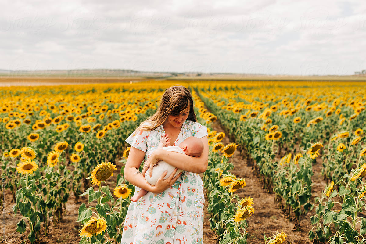 Mother and daughter in field of sunflowers