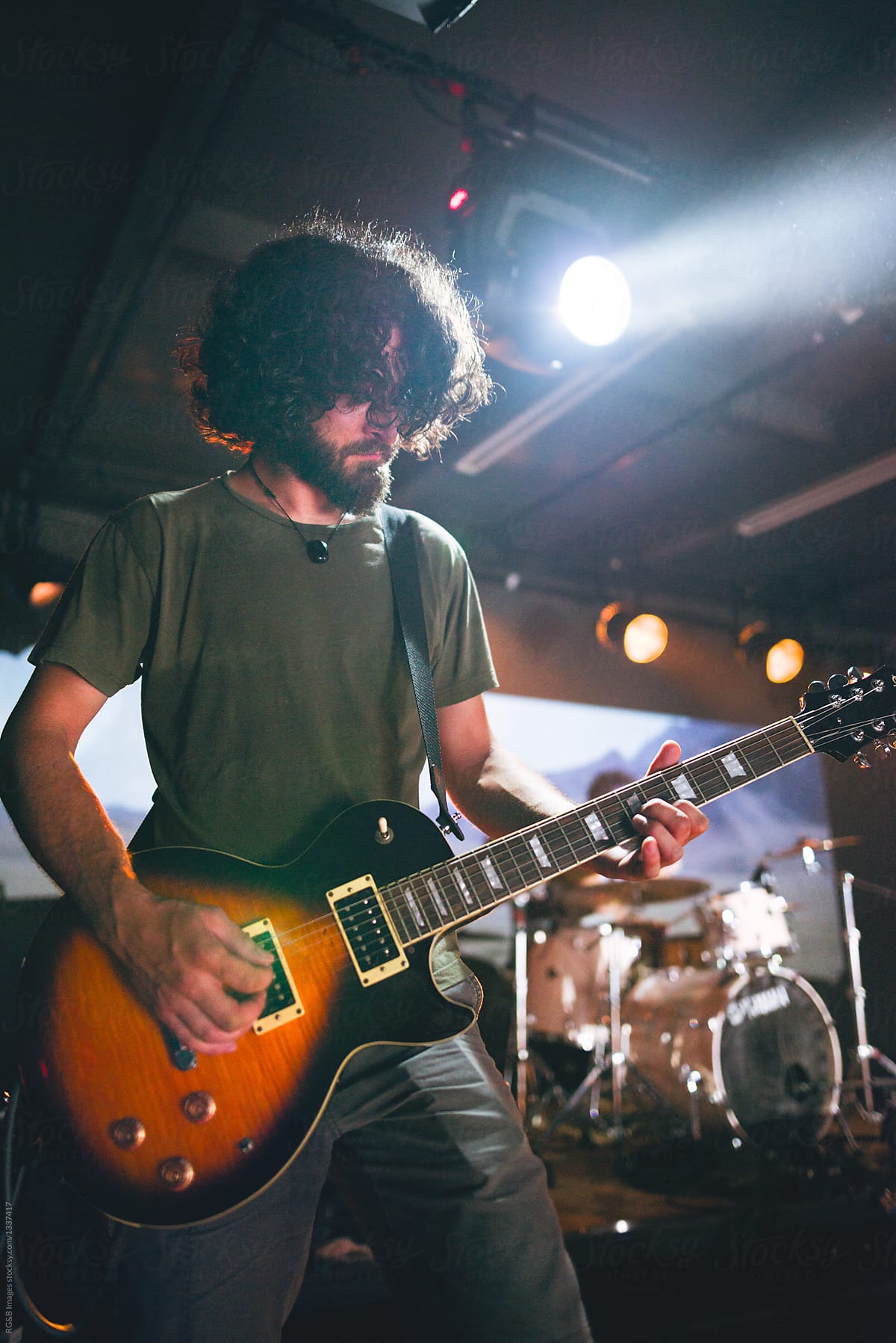 Portrait of bearded man playing electric guitar