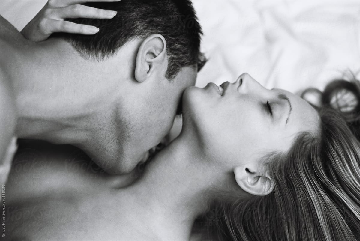 young couple making love, man kissing woman in the neck, here eyes are clos...