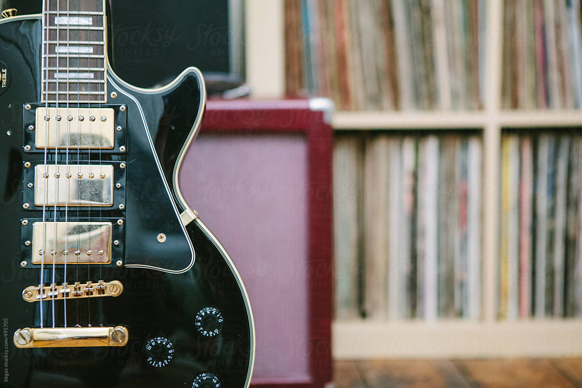 Guitar with amplifier in front of records