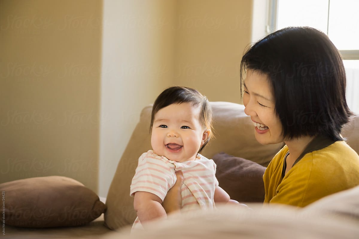 Asian mother and baby girl on a couch