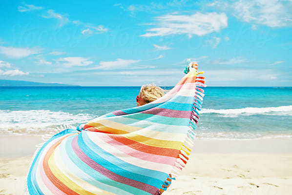 Girl In Bikini Taking Shirt Off At Beach With Ocean by Stocksy Contributor  Wendy Laurel - Stocksy