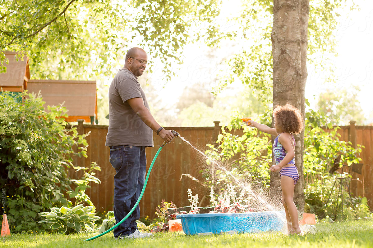 Father sprays daughter with hose
