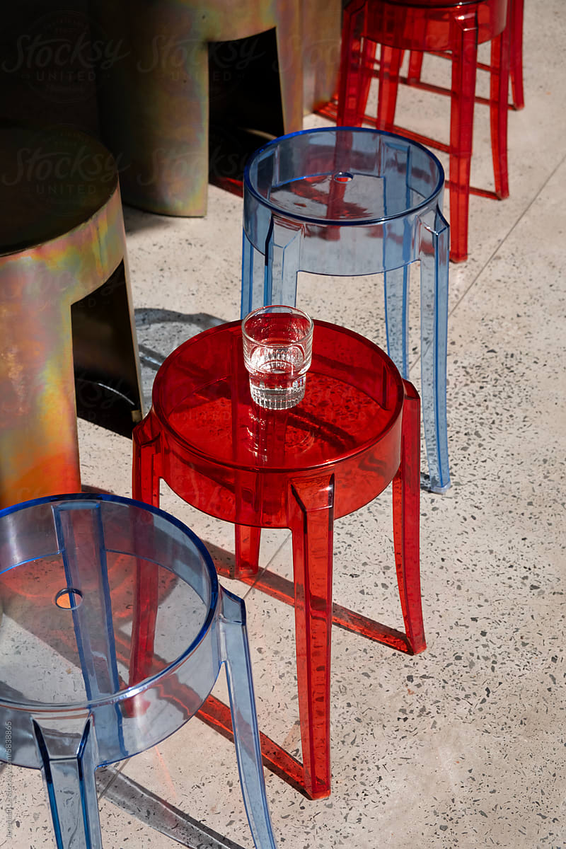 Transparent red and blue chairs with shadow