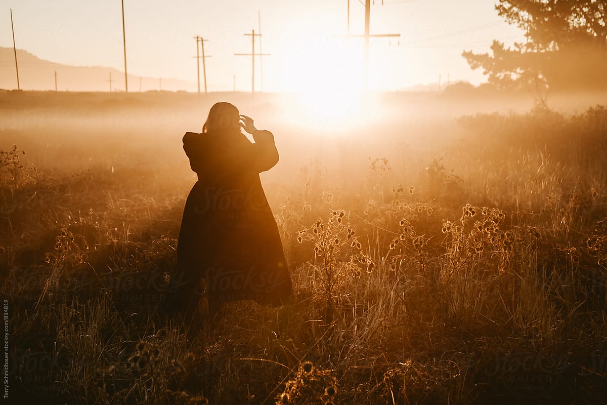 Woman in field at Sunrise