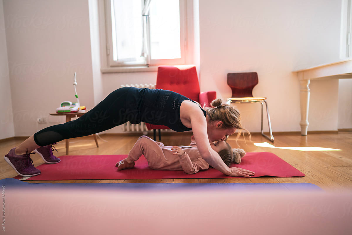 Mother and little daughter exercising at home